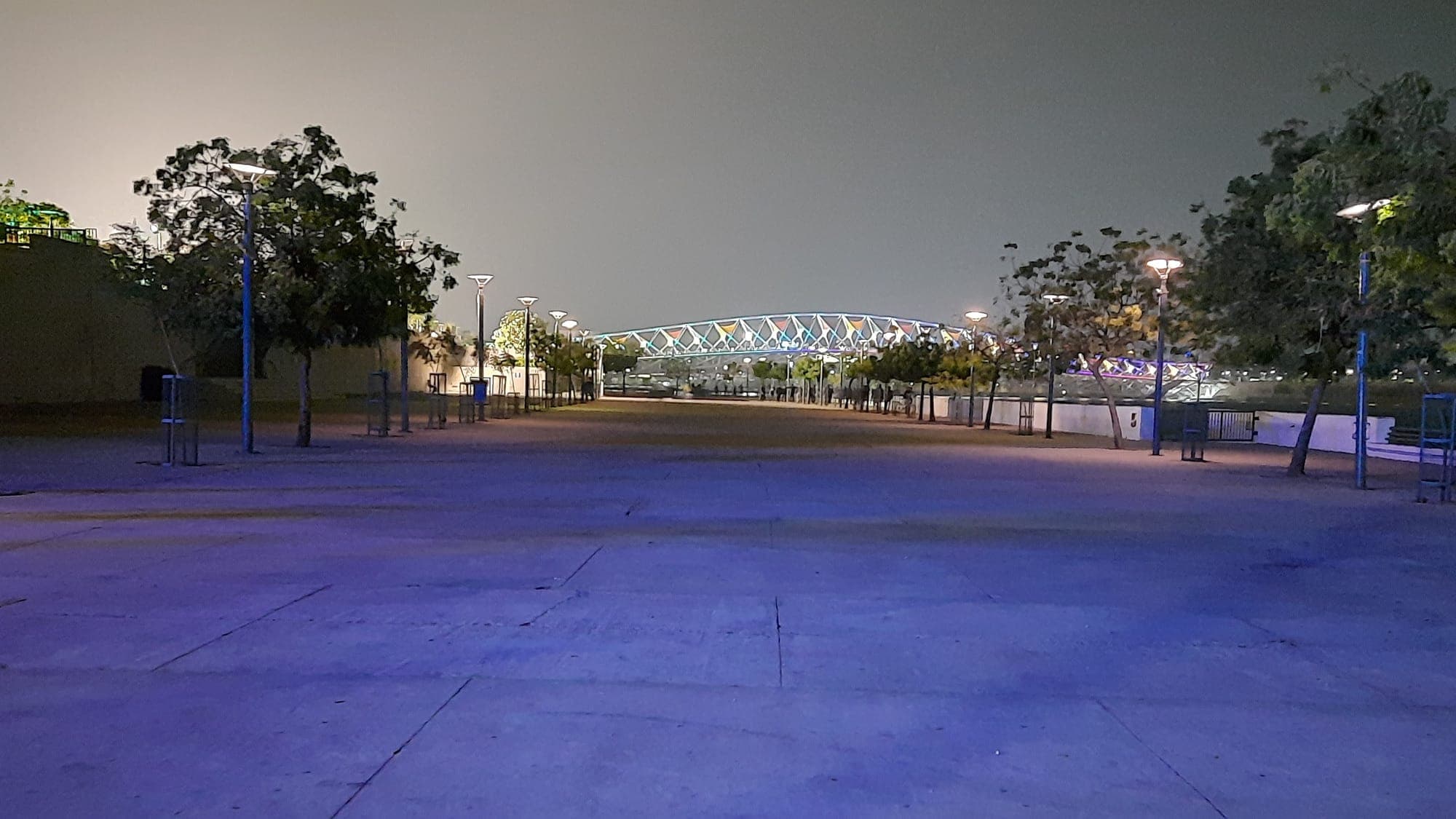 The Atal pedestrian bridge lit in colour over the Sabarmati river at night